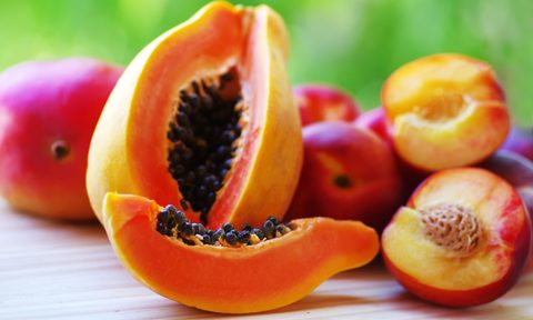Sliced papaya, mango, and nectarines on the table