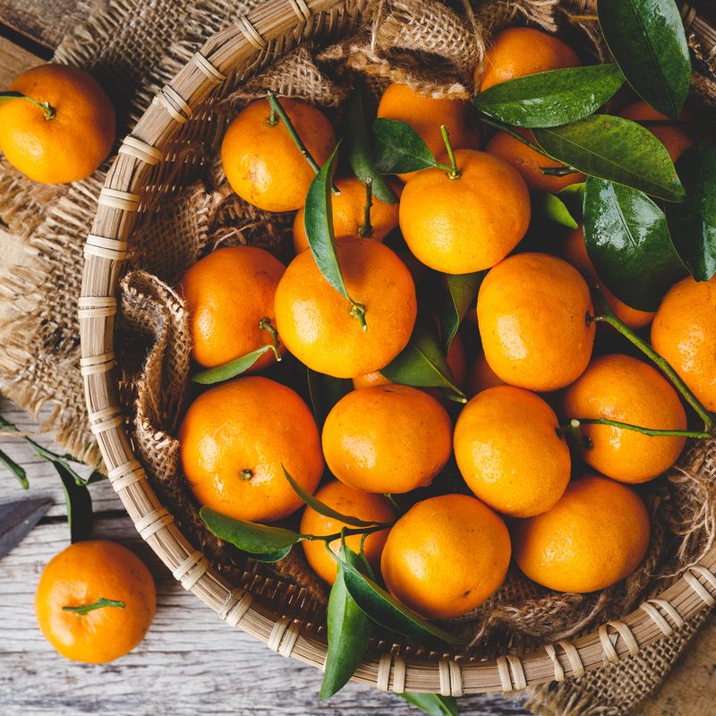 Above view of oranges In a basket on a table