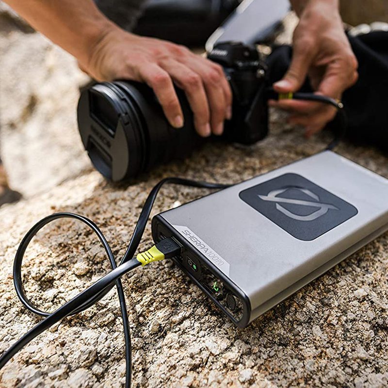 Power bank connected to a camera though a cord.