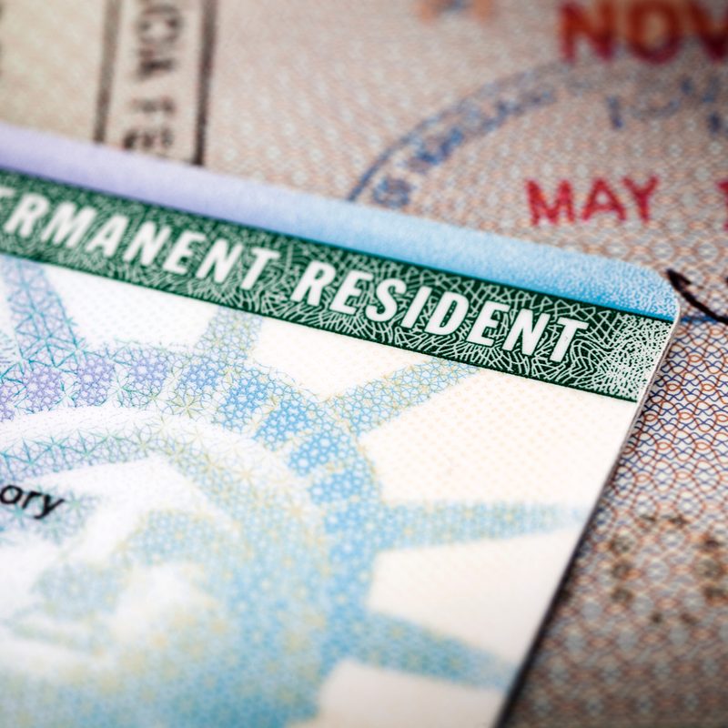 A person's Green Card sitting on a table.