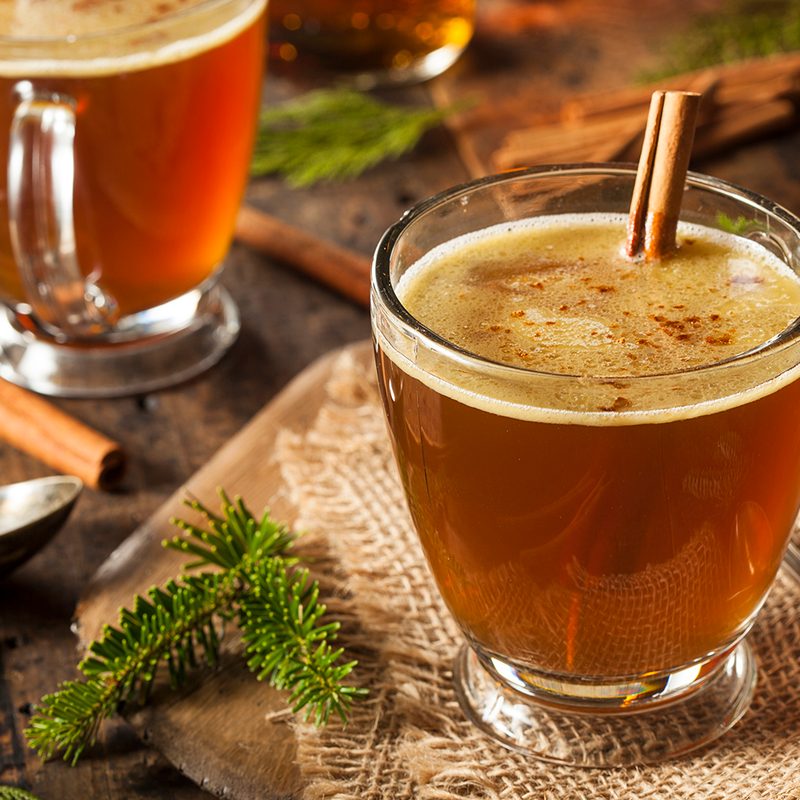 A hot buttered rum with cinnamon stick.