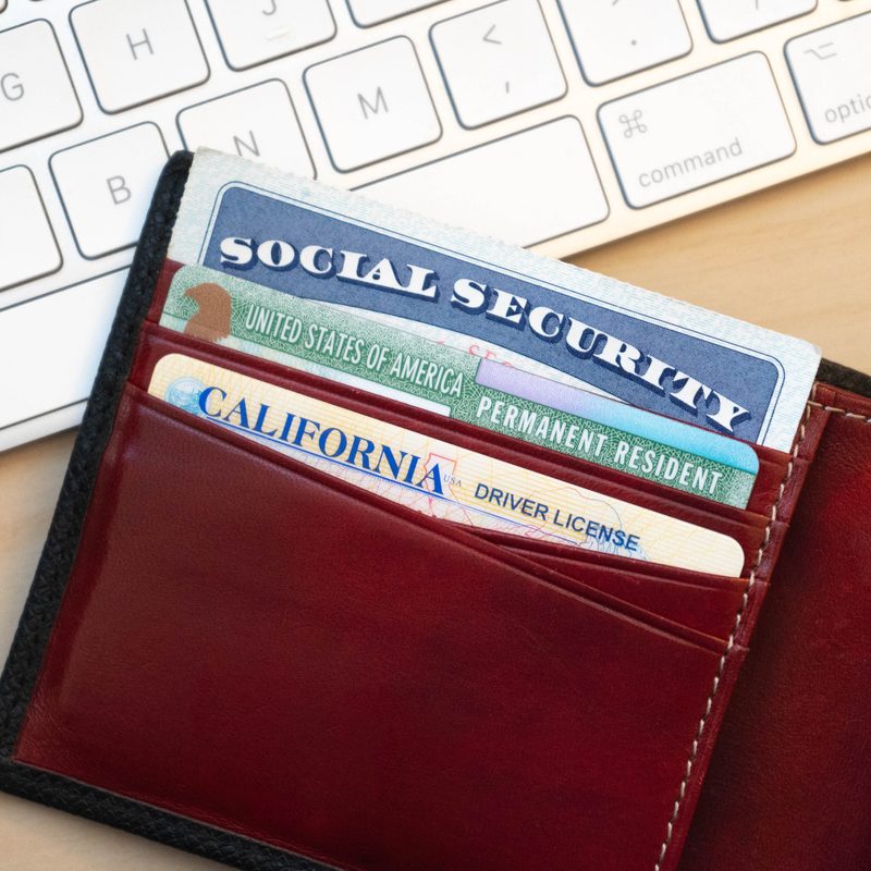 A social security card sticking out of a wallet.