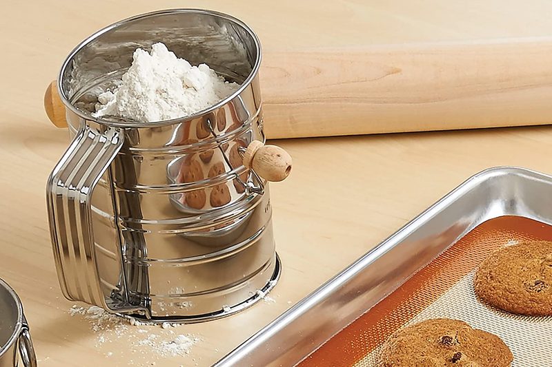 Flour sifter on kitchen countertop.