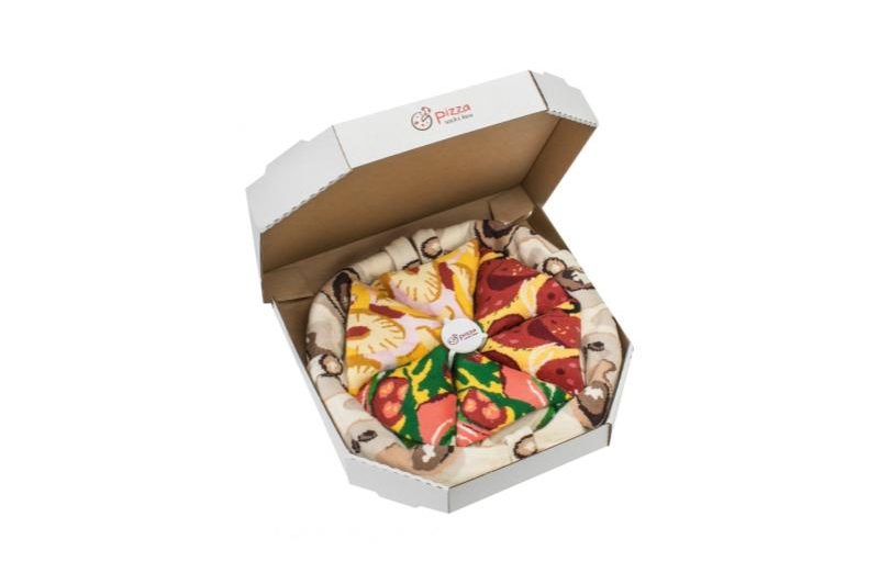 An open pizza box with Pizza Socks.