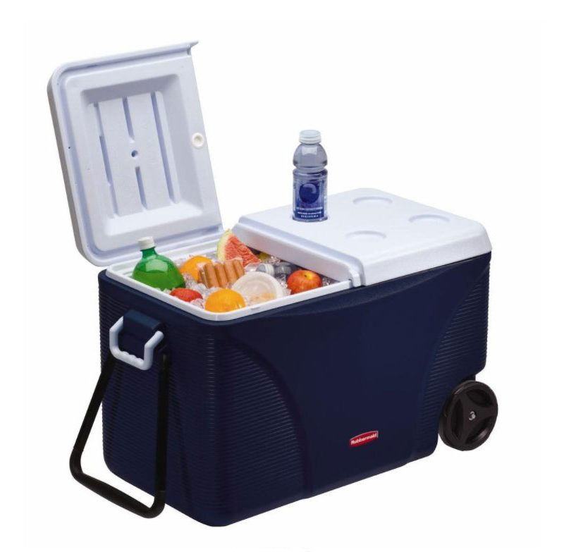 A blue Rubbermaid Durachill 5-Day Wheeled Cooler containing assorted food and drinks with a bottled water on top of it.