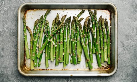 Oiled asparagus on a baking sheet