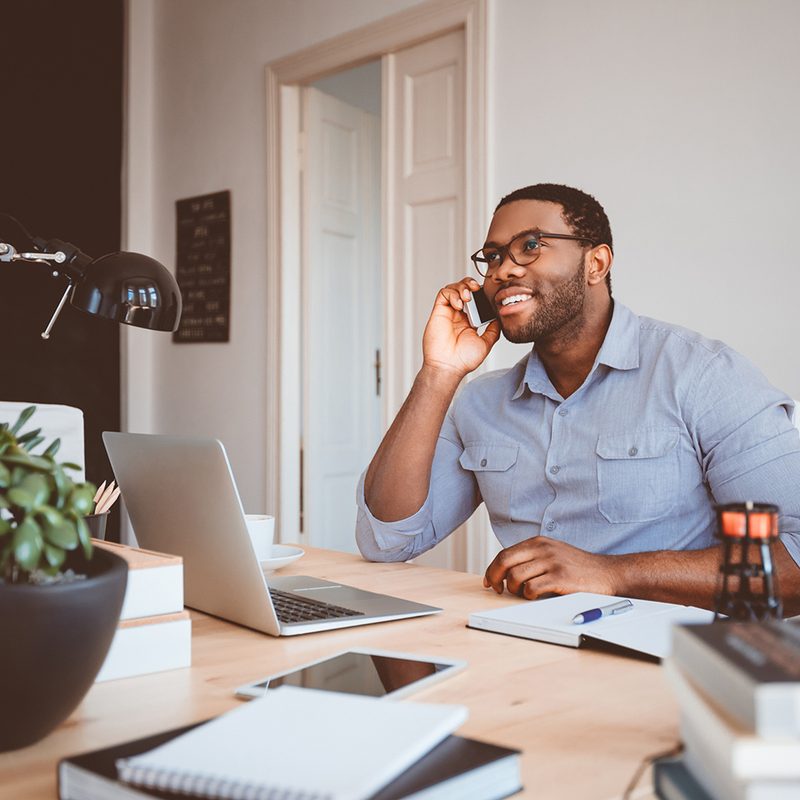 Man making a call while working at home.