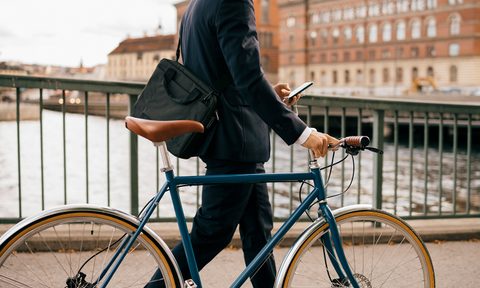 Man walking his road bike