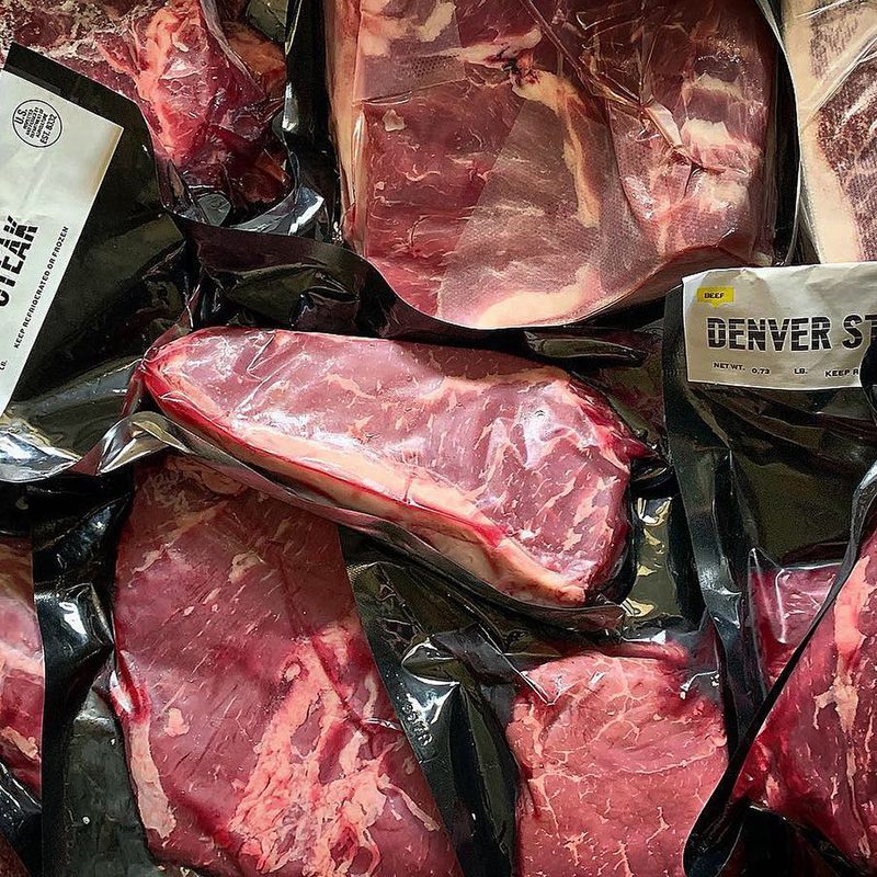 packaged steaks in a pile.