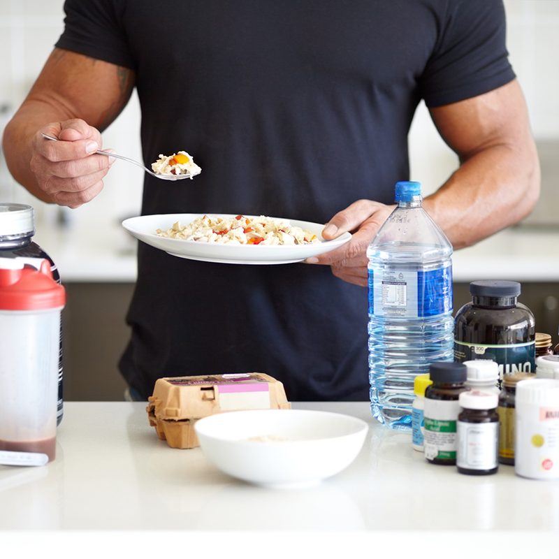 man eating a meal with water