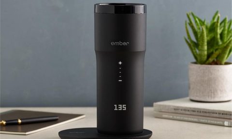 The Ember Travel Mug on a desk.
