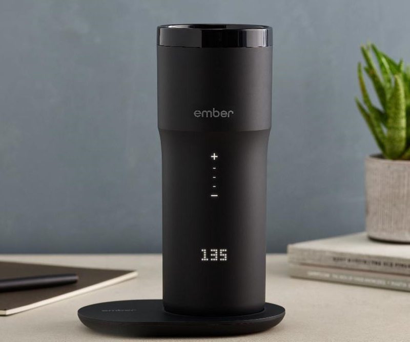 The Ember Travel Mug on a desk.