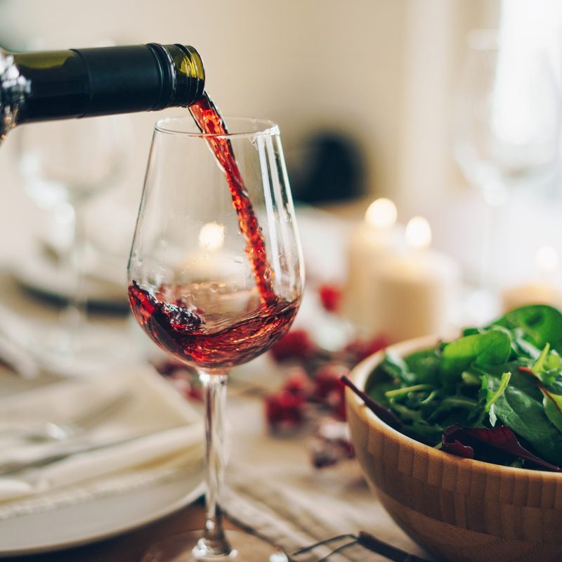 Red wine being poured into the glass