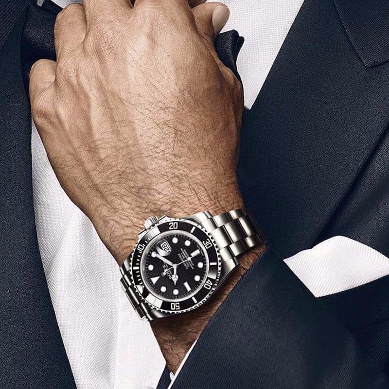 Man wearing a suit and a Rolex