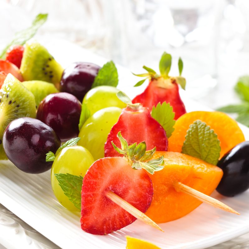 Strawberries. green grapes, kiwi, cherries, and apricots served on a stick
