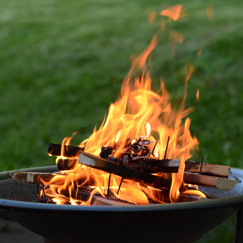 Fire pit burning wood on a patio