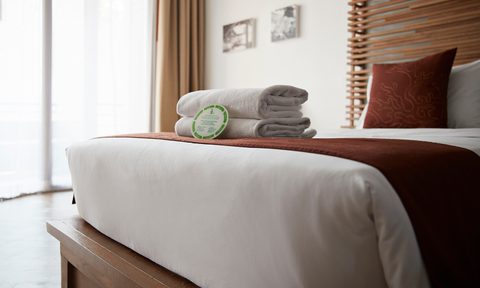 hotels sustainability covid19 towels on bed in hotel room