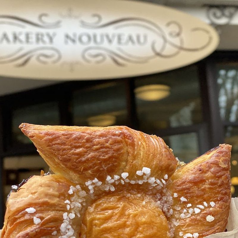 A close up of cream cheese Danish with Bakery Nouveau in the background.
