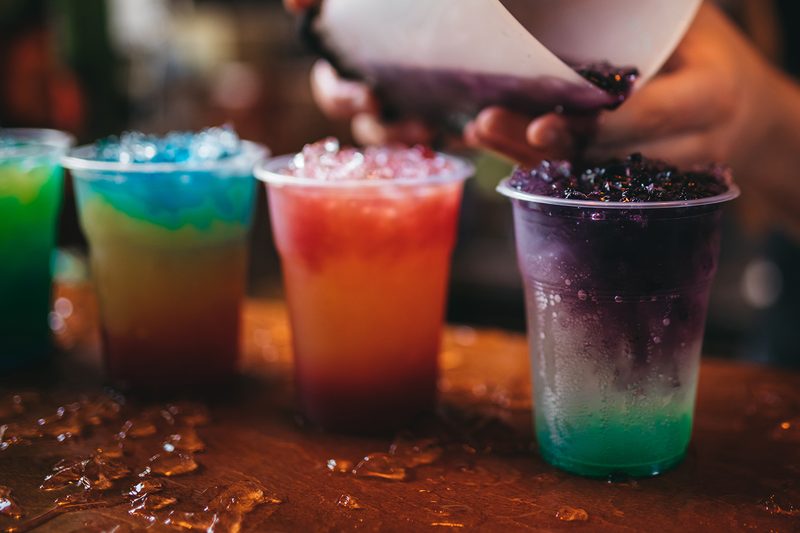 A lineup of frozen drinks.