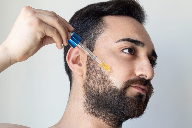 Man using shaving oil