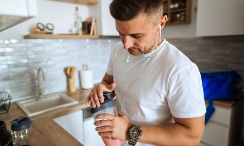 Man making a protein shake.
