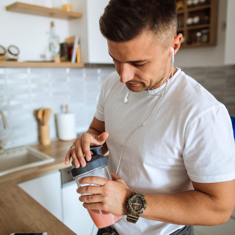 Man making a protein shake.