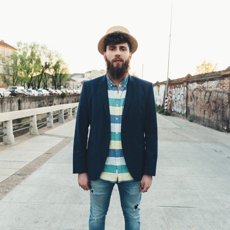 Portrait of man in straw boater by canal