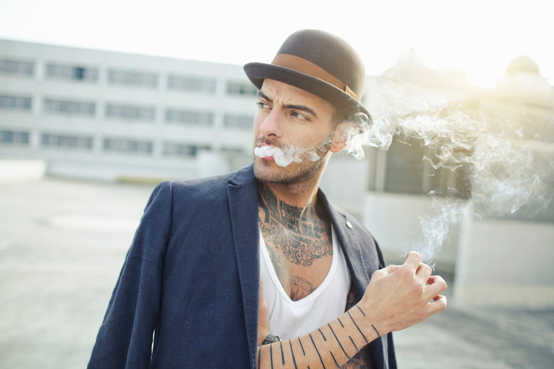 Man smoking in a derby hat