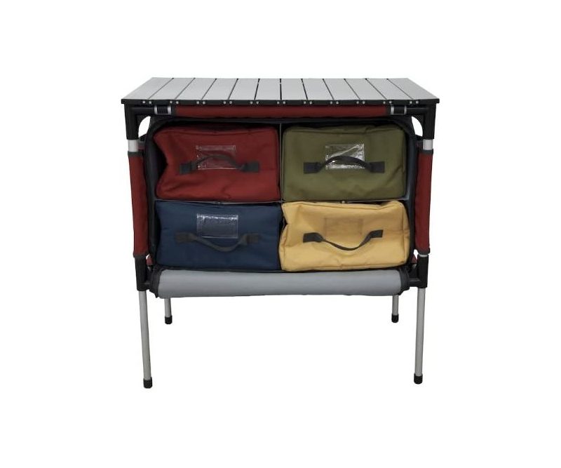 Color-coded totes stacked inside the Camp Chef Sherpa Camp Table & Organizer, isolated on a plain white background.