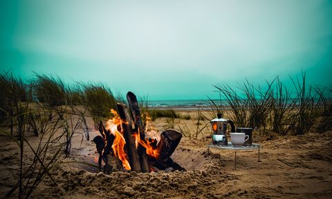 campfire with coffee folding table next to it