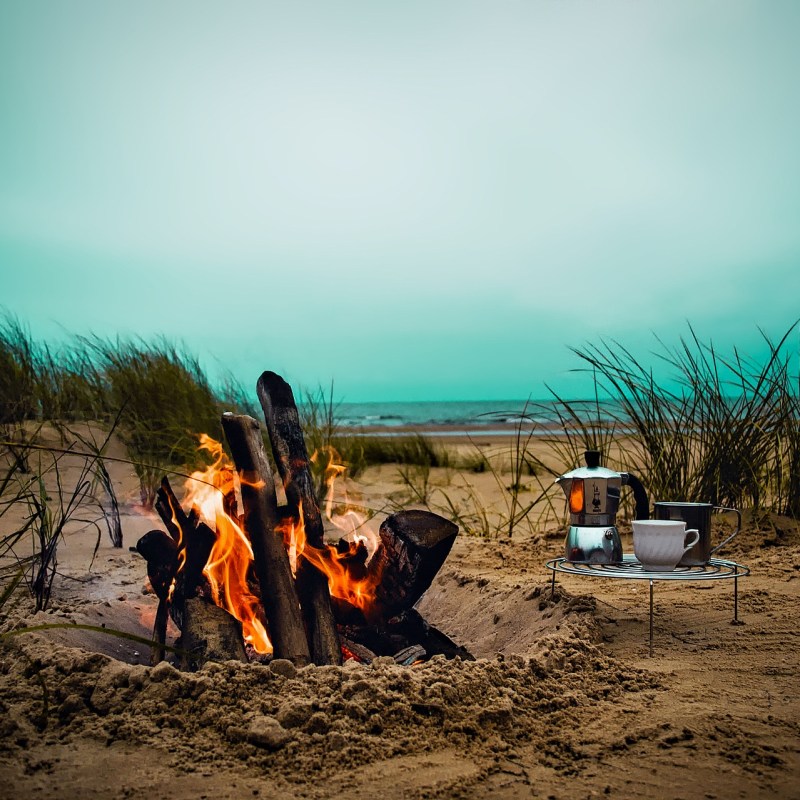 campfire with coffee folding table next to it