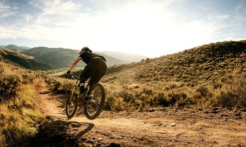 best bike chain lube woman flying on a downhill mountain
