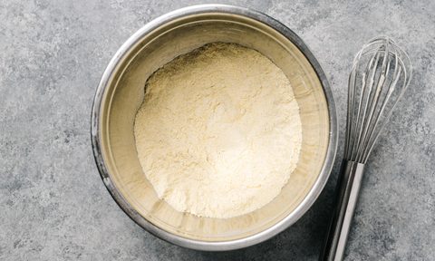 best cornbread mixes cornmeal mix in a stainless steel bowl with wire whisk