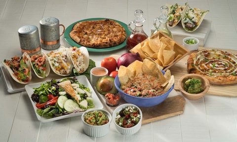 Various Mexican food on a table.