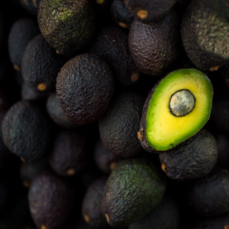 Very ripe and green avocados