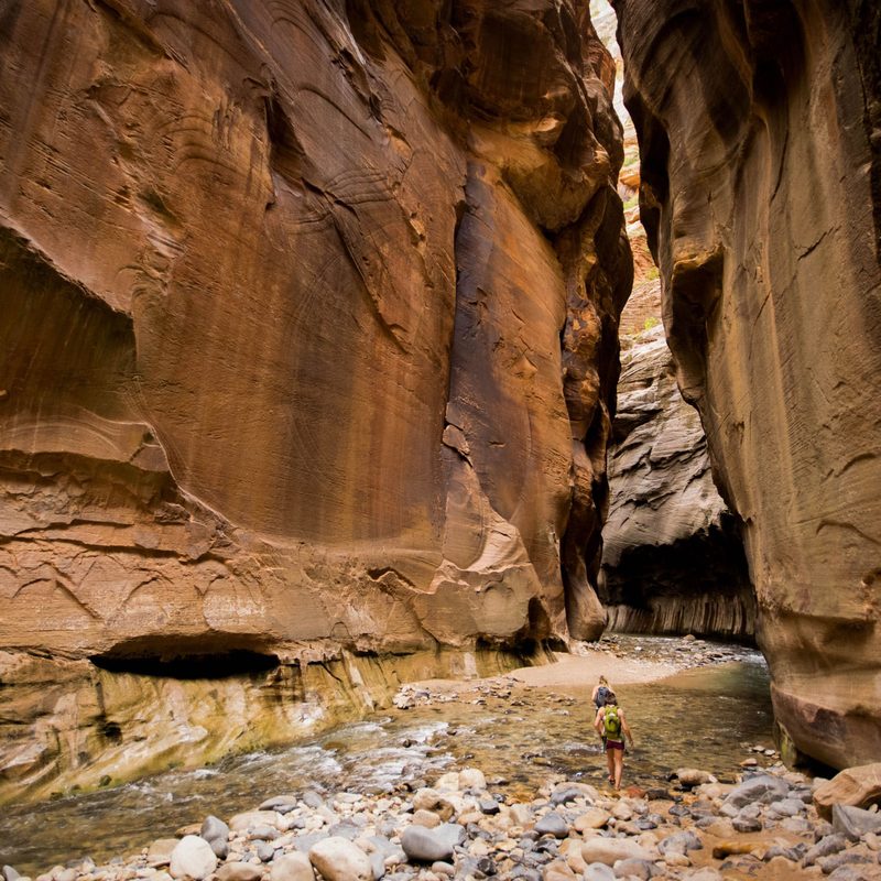 Hiker hiking The Narrows in Zion National Park, Utah