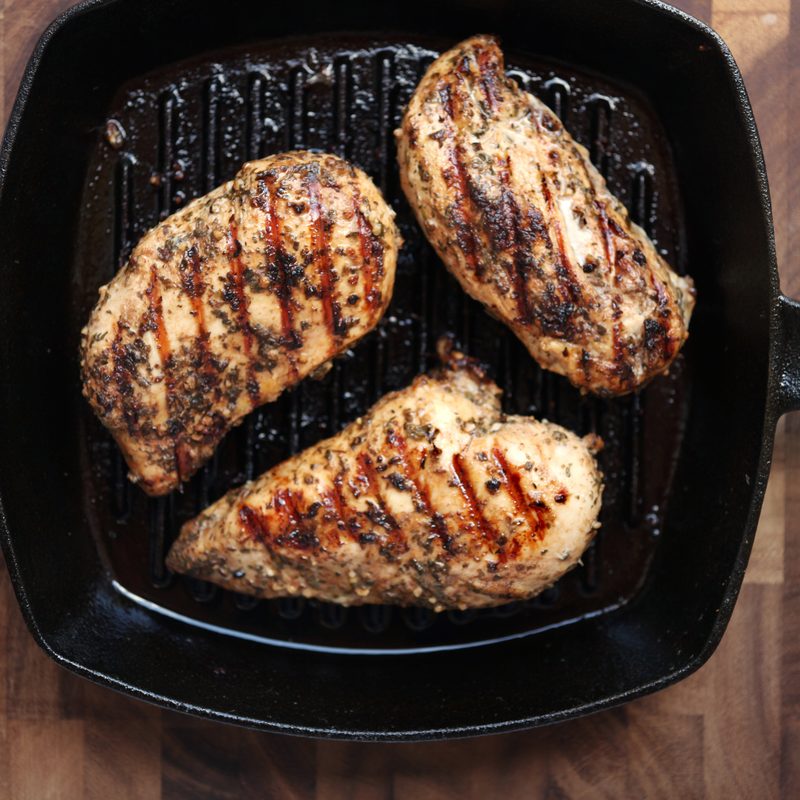 Healthy eating: grilled skinless, boneless chicken breasts in a cast iron grilling pan.