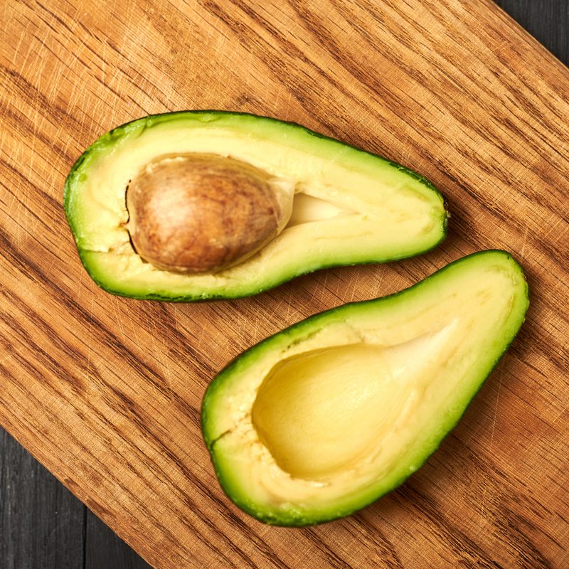 Sliced avocado on a wooden background