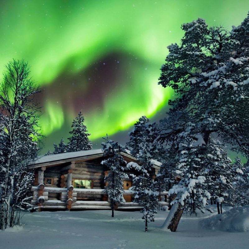 Finnish log cabin with northern lights above