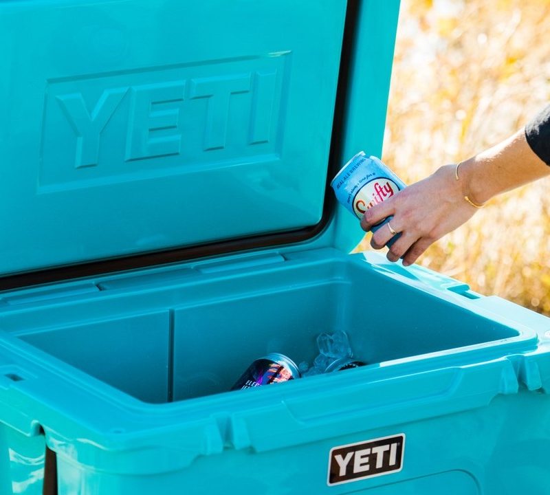Woman taking a drink out of a Yeti Cooler