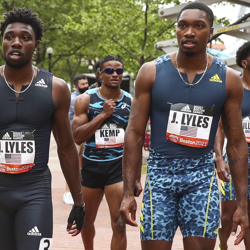 Four men running at a running event wearing Adidas gear