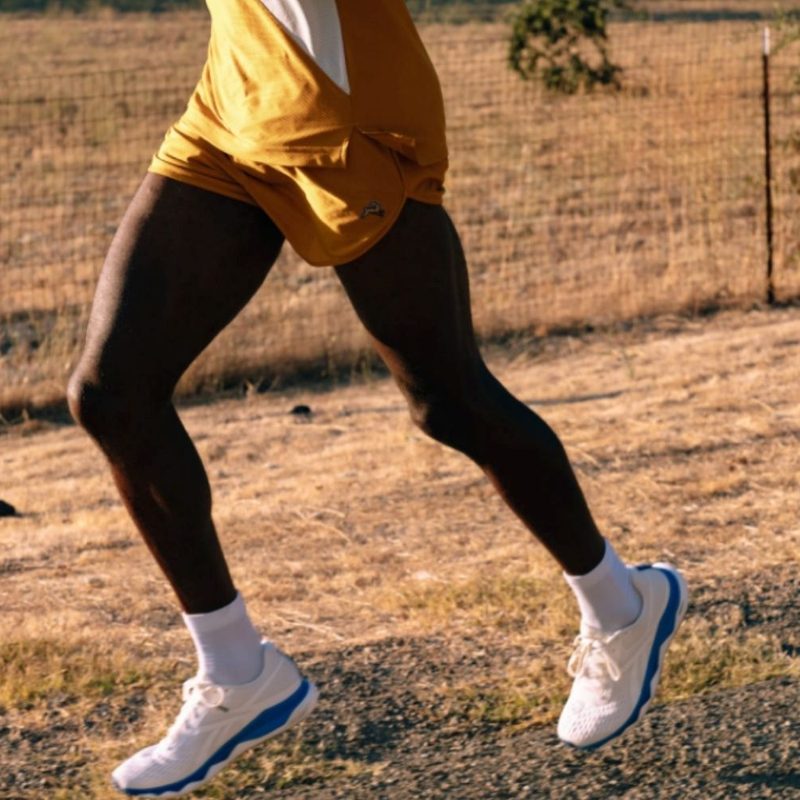 A figure running with Baleaf Running Shorts.