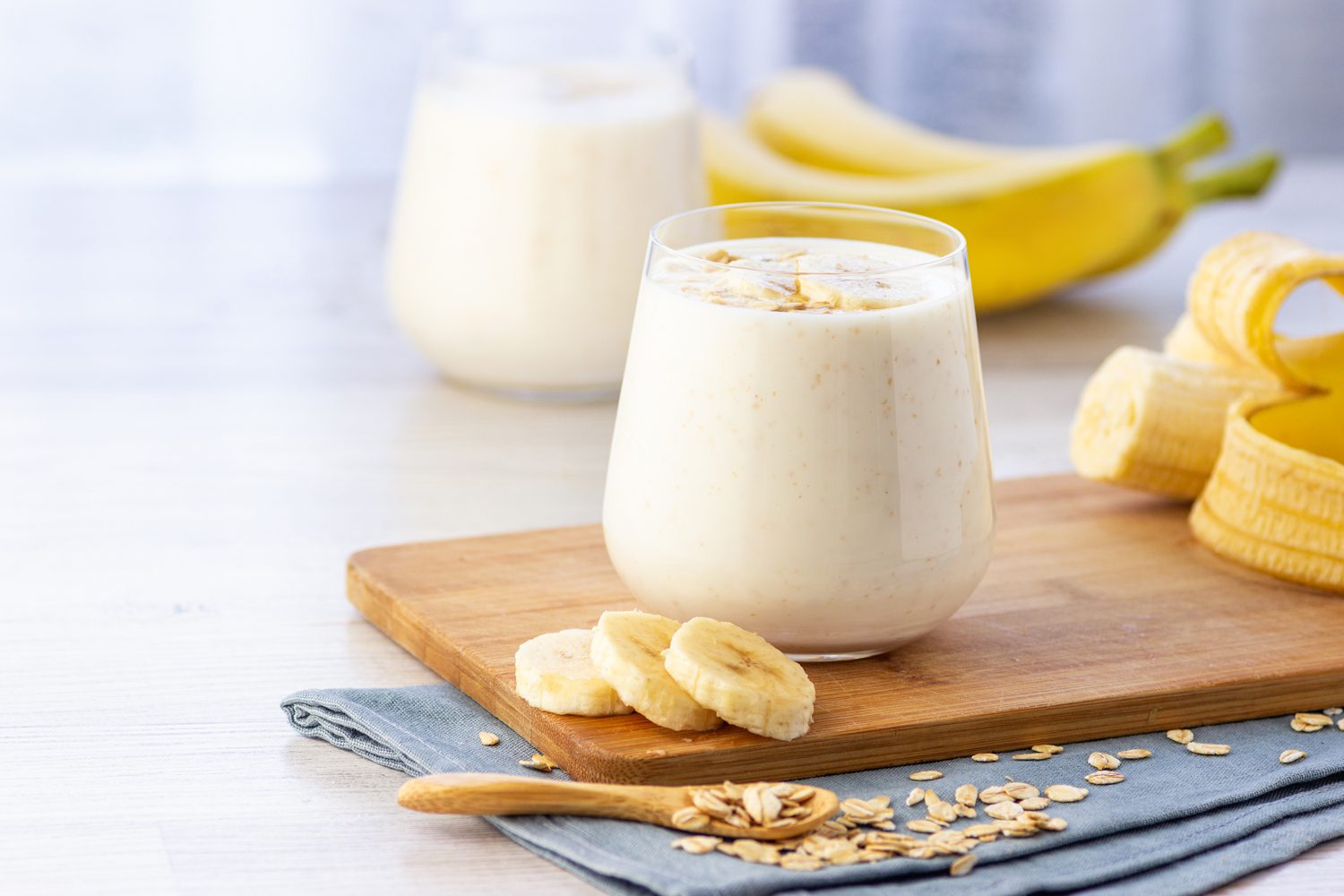 Banana smoothie in a glass on a counter.