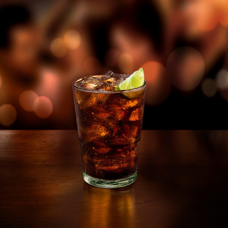 Cola in a glass with a lemon