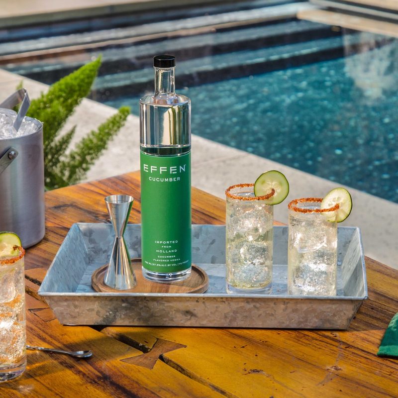 A bottle of EFFEN Cucumber Vodka with three glasses of EFFEN Cucumber Pepino Cocktail.