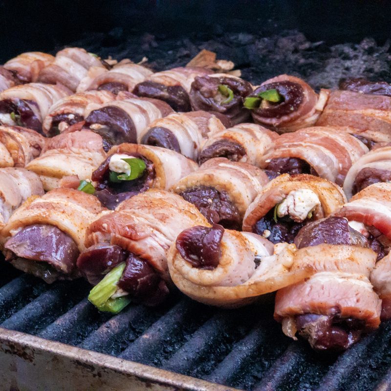 Outdoor barbecue grill grilled duck breast and dove breast wrapped in bacon filled with cheddar cheese and jalapeños