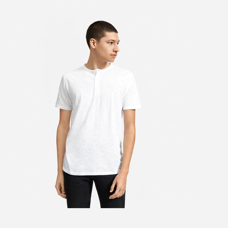 man wearing a white short sleeved henley shirt.