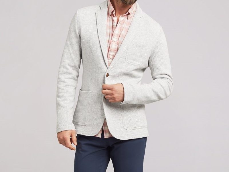 Model wearing a Faherty Inlet Knit gray Blazer and jeans.