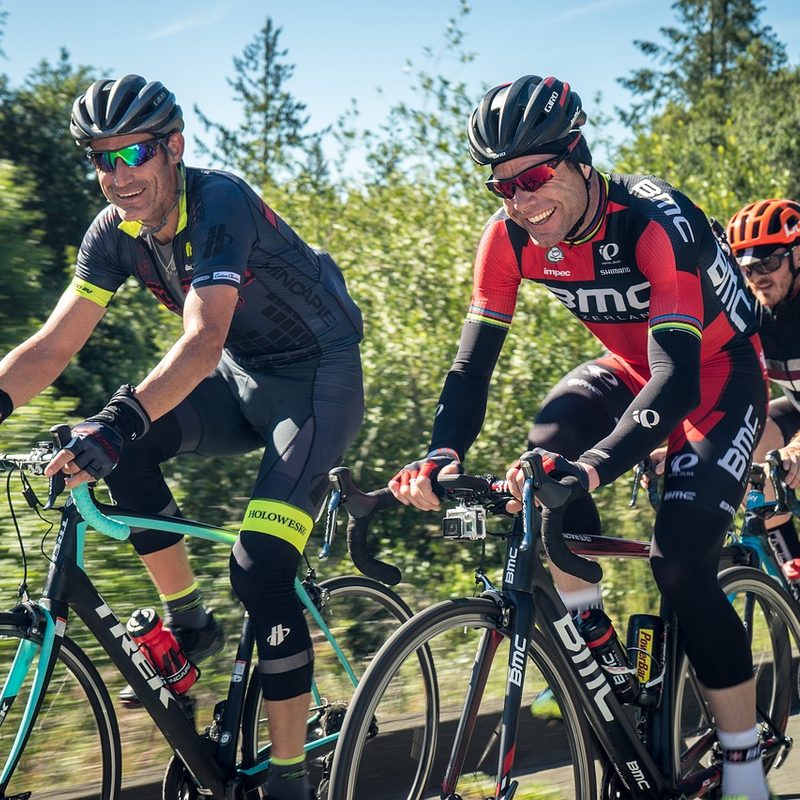 A ground of men cycling ourdoors.