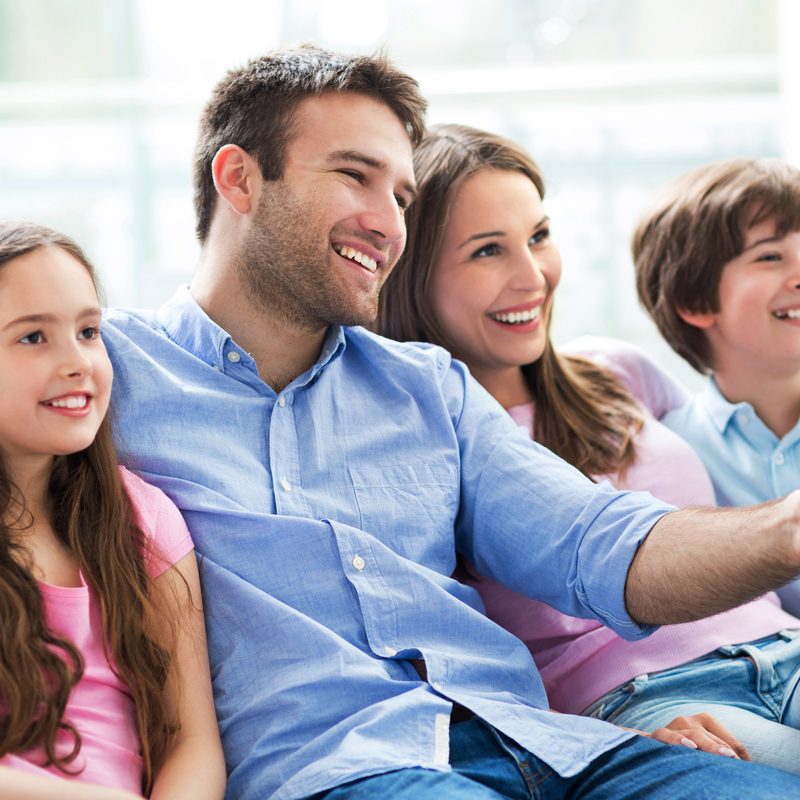 Family watching TV together